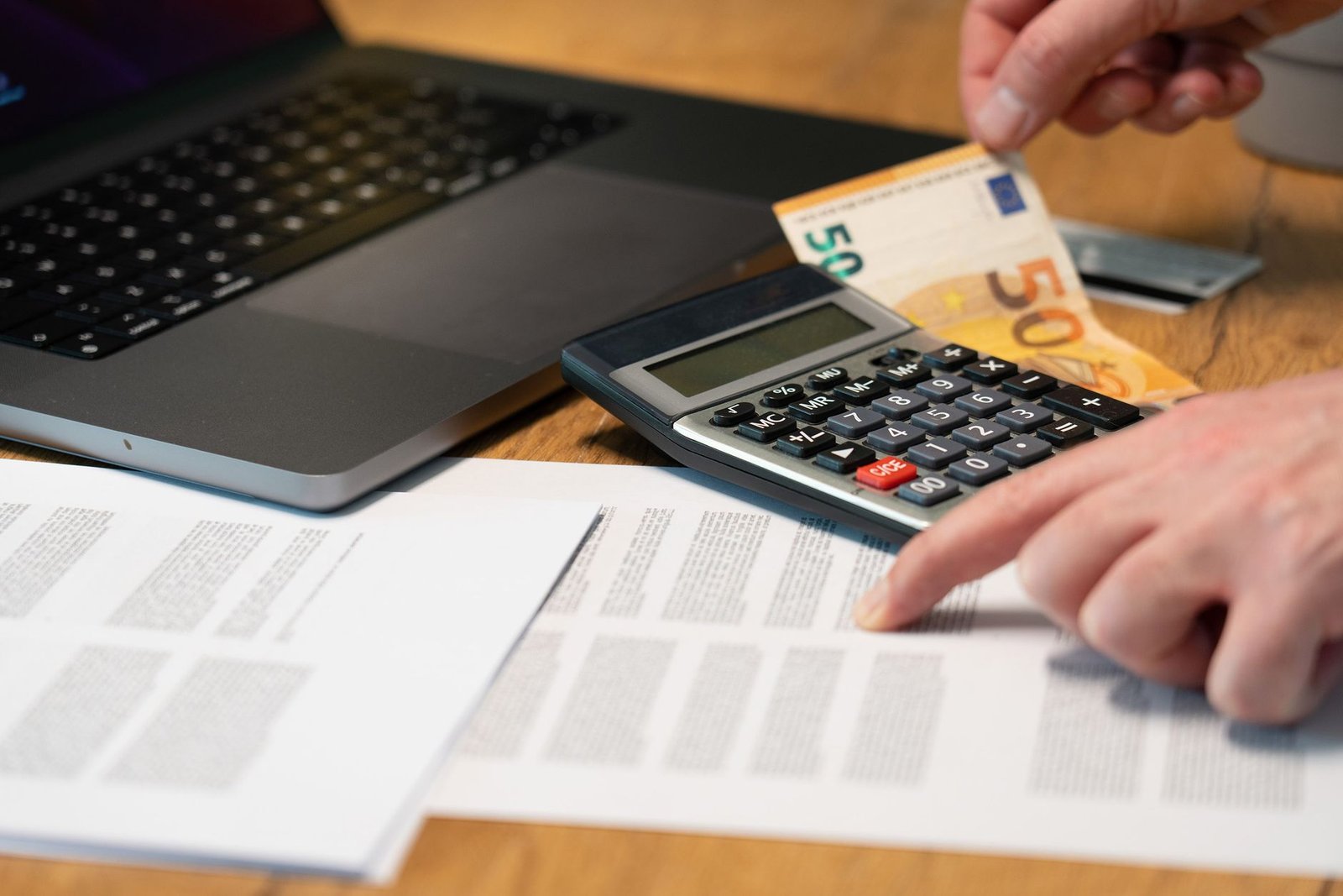 Calcul d'un budget publicitaire avec une calculatrice et des billets en euros