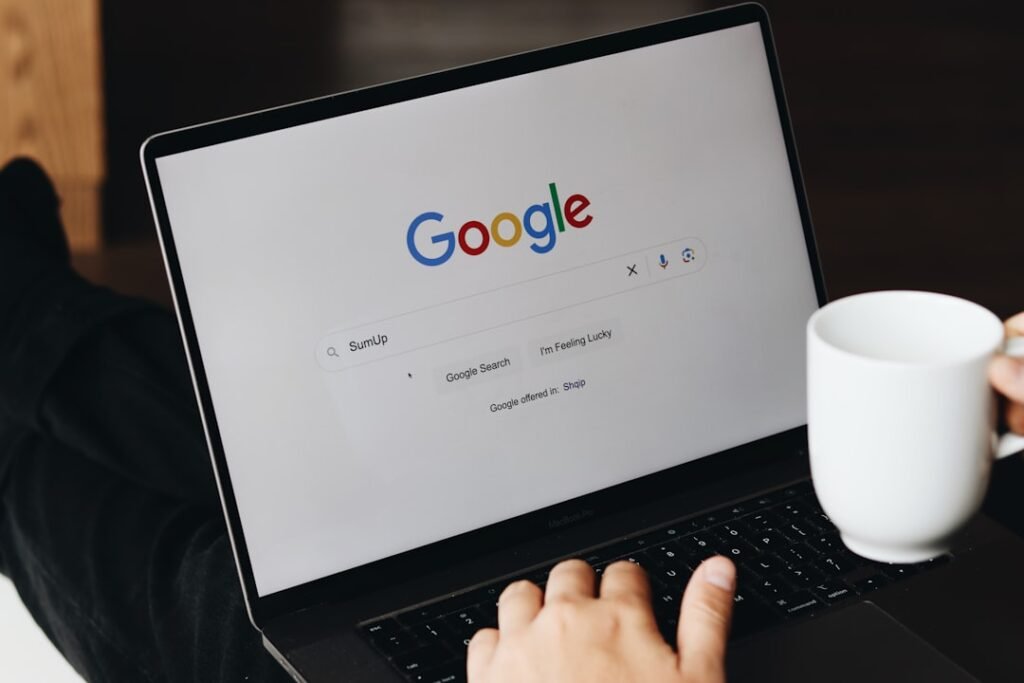 Personne saisissant une requête dans Google sur un ordinateur portable
